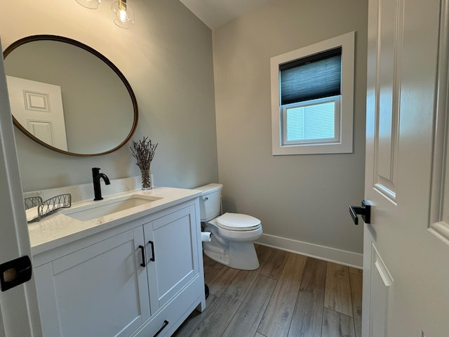 8460 Woodridge Dr, Davison, MI 48423 - bathroom with baseboards, toilet, wood finished floors, and vanity