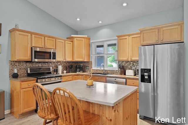 936 Amber View Dr SW Unit 160, Byron Center, MI 49315 - kitchen featuring stainless steel appliances, a sink, light brown cabinetry, backsplash, and light wood-type flooring