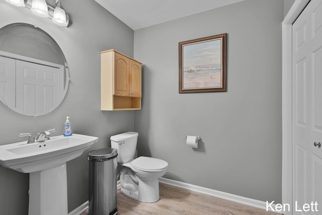 936 Amber View Dr SW Unit 160, Byron Center, MI 49315 - bathroom featuring toilet, wood finished floors, and baseboards
