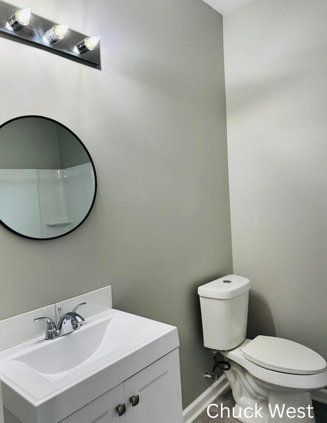 1479 Terrace St, Muskegon, MI 49442 - bathroom with toilet, vanity, and baseboards