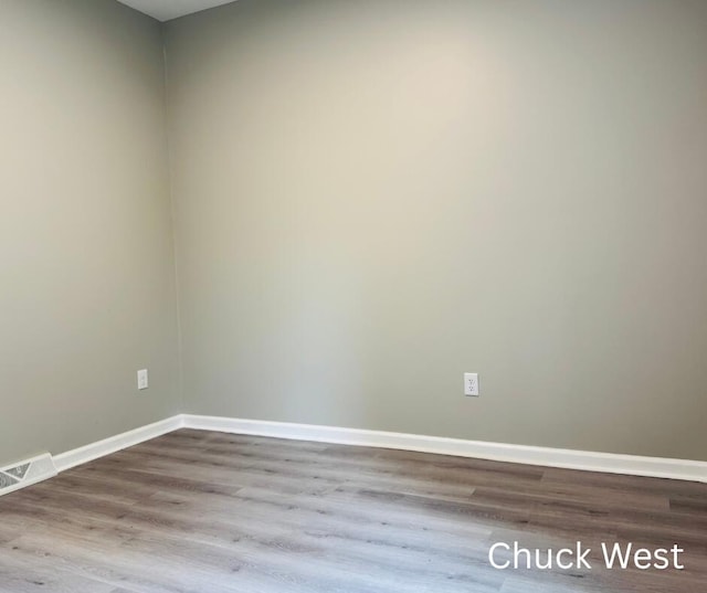 1479 Terrace St, Muskegon, MI 49442 - empty room featuring wood finished floors and baseboards