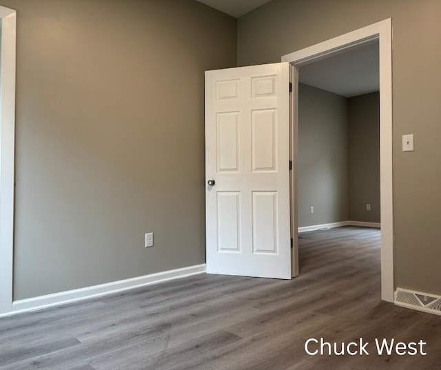 1479 Terrace St, Muskegon, MI 49442 - empty room with wood finished floors and baseboards