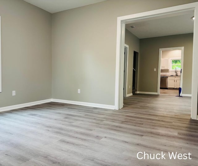 1479 Terrace St, Muskegon, MI 49442 - unfurnished room featuring a sink, wood finished floors, and baseboards
