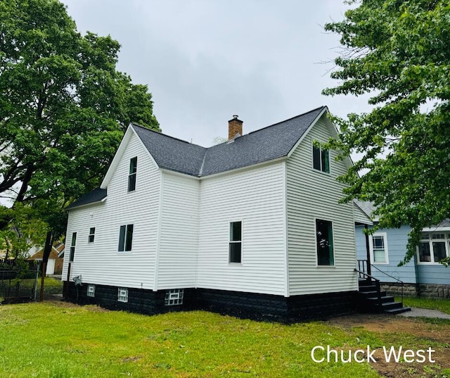 1479 Terrace St, Muskegon, MI 49442 - view of side of property with a chimney and roof with shingles