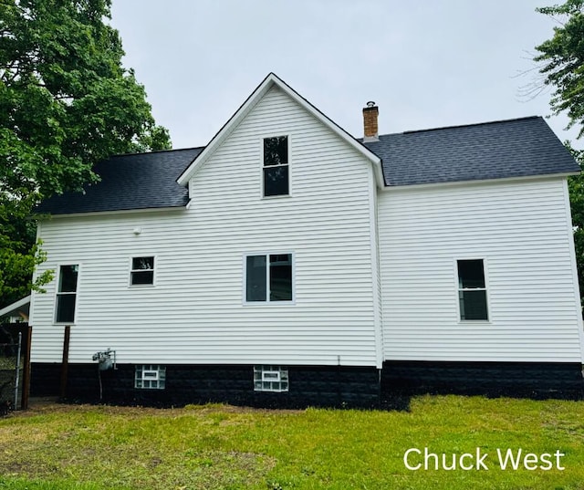1479 Terrace St, Muskegon, MI 49442 - view of home's exterior with a chimney, a lawn, and roof with shingles