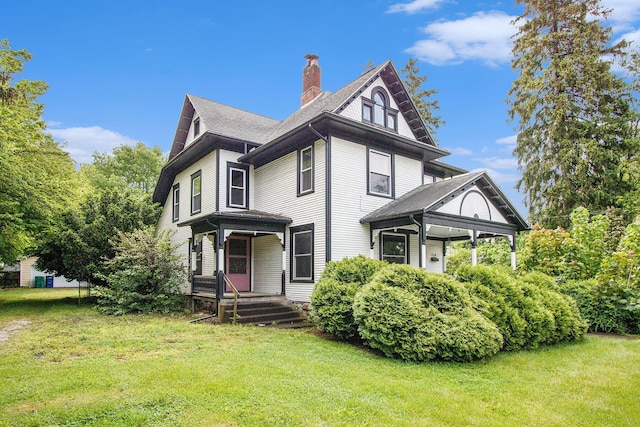 110 N O Keefe St, Cassopolis, MI 49031 - view of front of house featuring a chimney, a porch, a front lawn, and roof with shingles