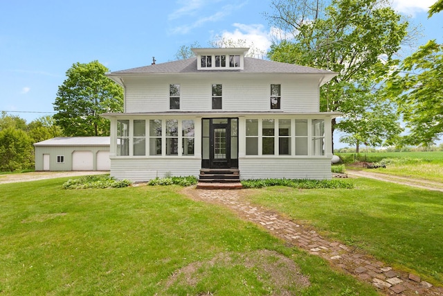 8001 S Jackson Rd, Jackson, MI 49201 - traditional style home with a sunroom, a front yard, an outdoor structure, a shingled roof, and a garage
