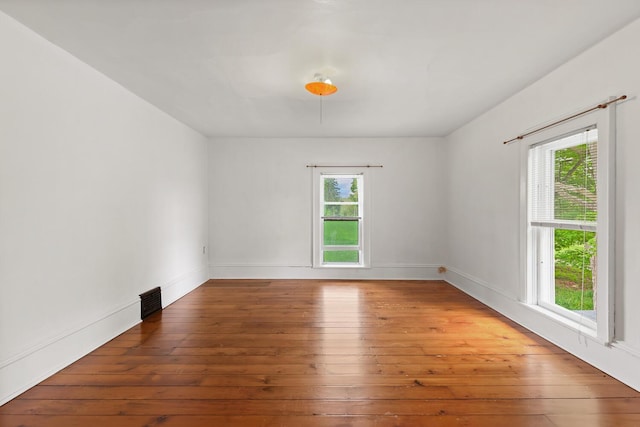 8001 S Jackson Rd, Jackson, MI 49201 - unfurnished room with plenty of natural light, hardwood / wood-style floors, and baseboards