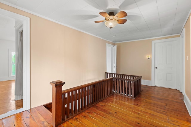 8001 S Jackson Rd, Jackson, MI 49201 - unfurnished room with hardwood / wood-style flooring, a ceiling fan, baseboards, and crown molding