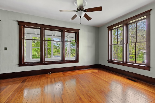 8001 S Jackson Rd, Jackson, MI 49201 - spare room featuring baseboards, ceiling fan, and hardwood / wood-style flooring