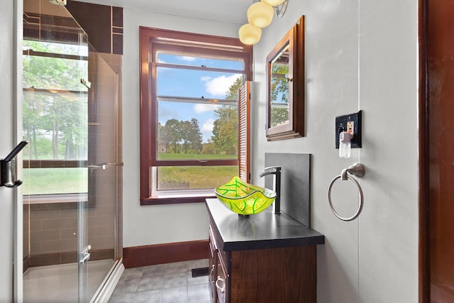 8001 S Jackson Rd, Jackson, MI 49201 - full bathroom with a shower stall, vanity, baseboards, and tile patterned floors