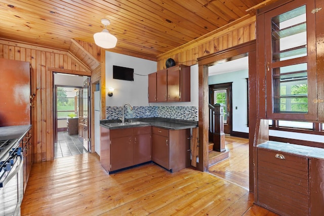 8001 S Jackson Rd, Jackson, MI 49201 - kitchen featuring a sink, dark countertops, wall oven, light wood-style floors, and tasteful backsplash