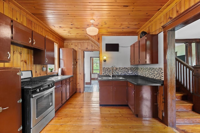 8001 S Jackson Rd, Jackson, MI 49201 - kitchen featuring stainless steel range with gas stovetop, a sink, dark countertops, decorative backsplash, and wood ceiling