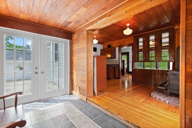 8001 S Jackson Rd, Jackson, MI 49201 - foyer with wood ceiling, french doors, wood walls, a wood stove, and healthy amount of natural light