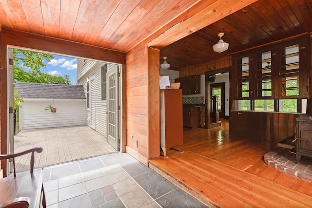 8001 S Jackson Rd, Jackson, MI 49201 - unfurnished sunroom with a wood stove