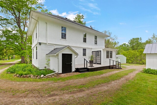 8001 S Jackson Rd, Jackson, MI 49201 - back of house featuring a deck and an outbuilding