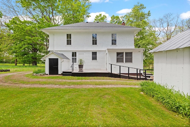 8001 S Jackson Rd, Jackson, MI 49201 - back of house with a chimney, a lawn, and a wooden deck