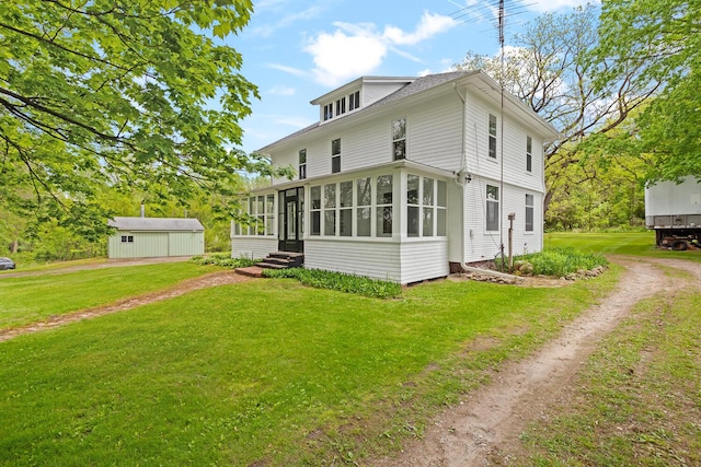 8001 S Jackson Rd, Jackson, MI 49201 - view of front of property with a sunroom, dirt driveway, a front yard, and entry steps