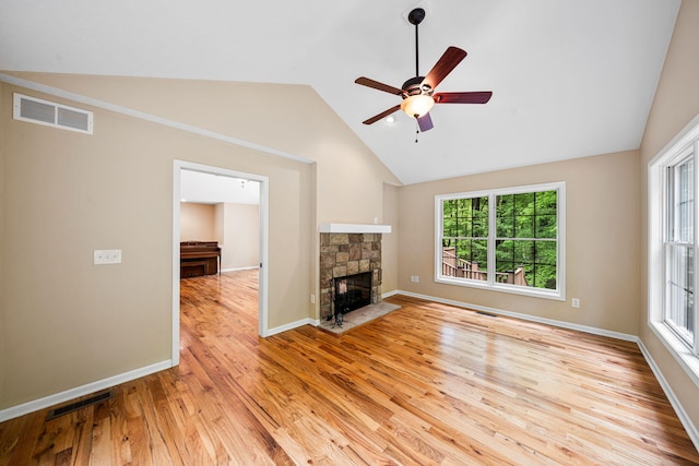 64711 Shorewood Ln, Cassopolis, MI 49031 - unfurnished living room with lofted ceiling, light wood-style flooring, a ceiling fan, a fireplace, and baseboards