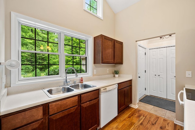 64711 Shorewood Ln, Cassopolis, MI 49031 - kitchen with dishwasher, a sink, high vaulted ceiling, light countertops, and light wood-type flooring