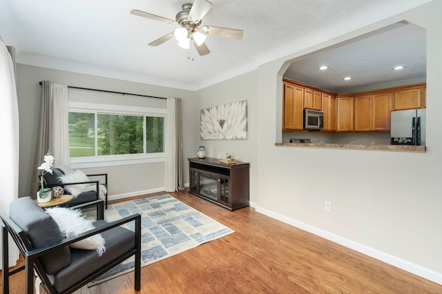 4121 Quebec St, Auburn Hills, MI 48326 - living area with light wood-style flooring, baseboards, recessed lighting, a ceiling fan, and arched walkways