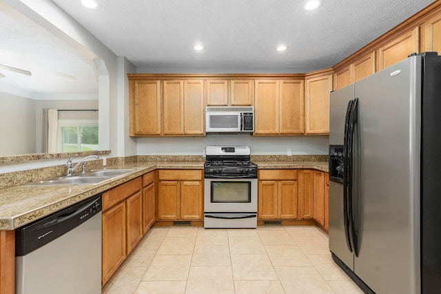 4121 Quebec St, Auburn Hills, MI 48326 - kitchen with stainless steel appliances, a sink, recessed lighting, light tile patterned floors, and brown cabinets