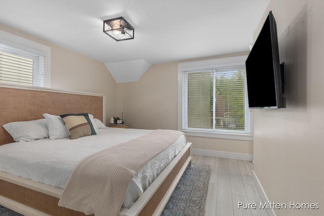 912 Arianna St NW, Grand Rapids, MI 49504 - bedroom with baseboards, light wood finished floors, and vaulted ceiling