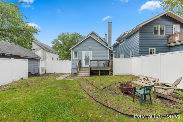 912 Arianna St NW, Grand Rapids, MI 49504 - back of house featuring a fire pit and a deck