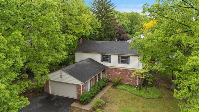 4948 Hardwoods Dr, West Bloomfield, MI 48323 - view of side of property with brick siding, asphalt driveway, a garage, and a chimney