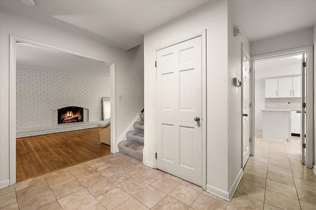 4948 Hardwoods Dr, West Bloomfield, MI 48323 - corridor featuring stairway, light tile patterned flooring, and baseboards