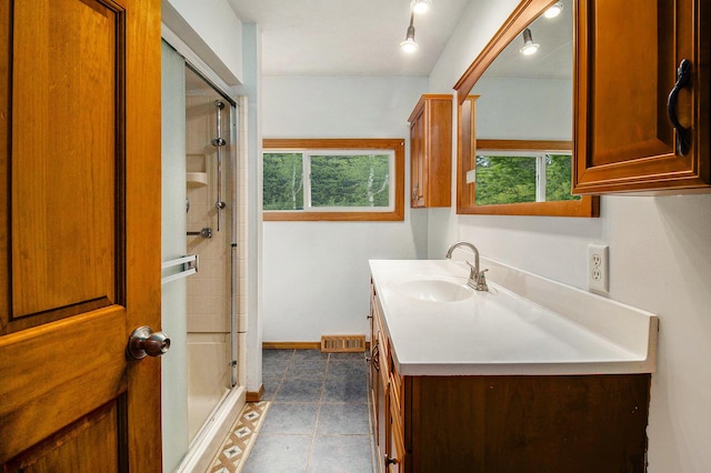 4771 S Lakeshore Dr, Ludington, MI 49431 - full bathroom featuring healthy amount of natural light, a stall shower, vanity, and baseboards
