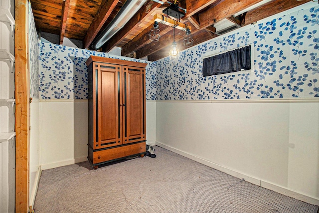 4771 S Lakeshore Dr, Ludington, MI 49431 - unfinished basement featuring a wainscoted wall, wallpapered walls, baseboards, and light colored carpet
