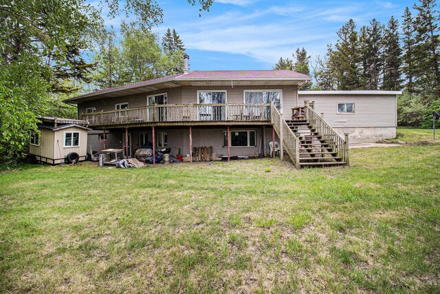 4771 S Lakeshore Dr, Ludington, MI 49431 - back of house featuring a wooden deck, stairs, and a yard