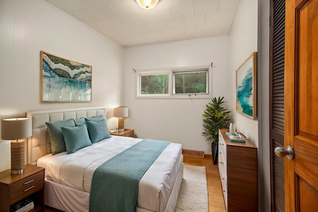 4771 S Lakeshore Dr, Ludington, MI 49431 - bedroom featuring light wood finished floors and crown molding