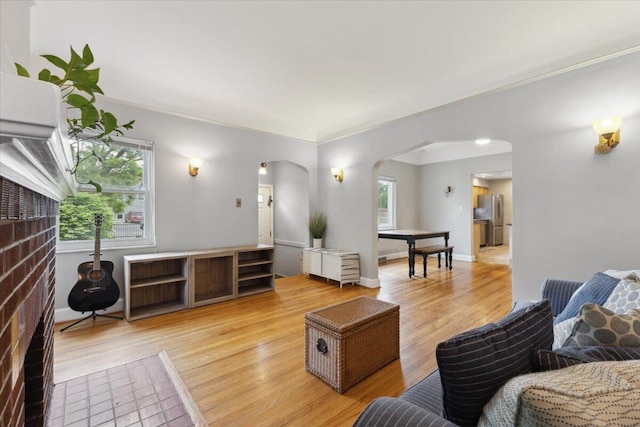 3364 Inman St, Ferndale, MI 48220 - living room featuring arched walkways, light wood-style floors, baseboards, and ornamental molding