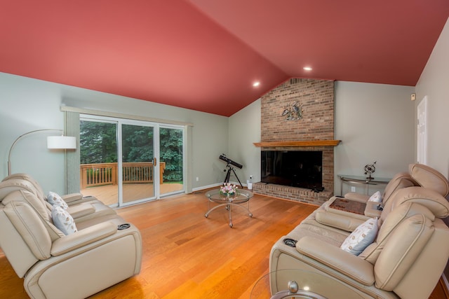 24609 Redwing Dr, Novi, MI 48374 - living area featuring vaulted ceiling, wood finished floors, a brick fireplace, and baseboards