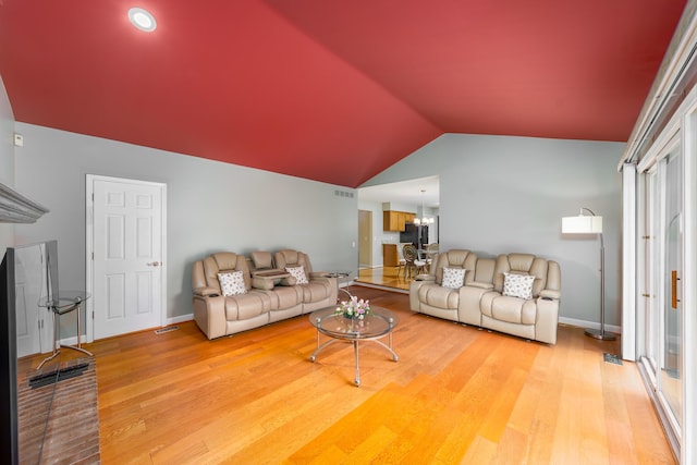 24609 Redwing Dr, Novi, MI 48374 - living area with vaulted ceiling, light wood-type flooring, and baseboards