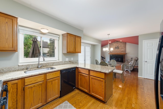 24609 Redwing Dr, Novi, MI 48374 - kitchen with a sink, black dishwasher, a peninsula, healthy amount of natural light, and lofted ceiling