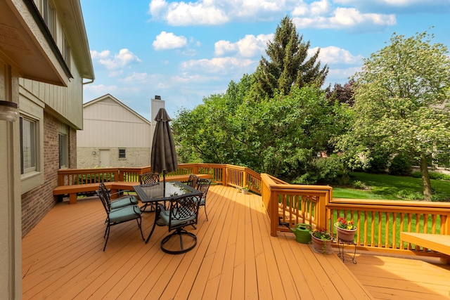 24609 Redwing Dr, Novi, MI 48374 - wooden deck with outdoor dining area and a lawn