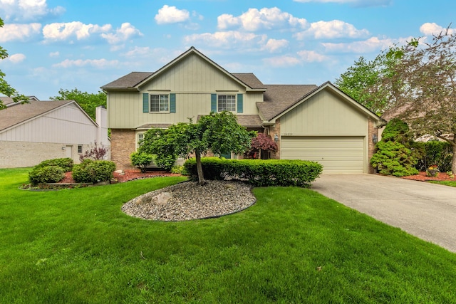 24609 Redwing Dr, Novi, MI 48374 - traditional home featuring driveway, a garage, a front yard, a shingled roof, and brick siding