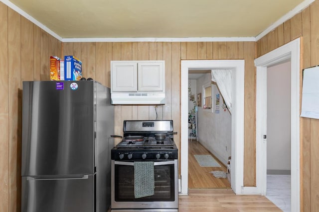 2113 Palace Ave SW, Grand Rapids, MI 49507 - kitchen with stainless steel appliances, under cabinet range hood, light wood finished floors, and wood walls
