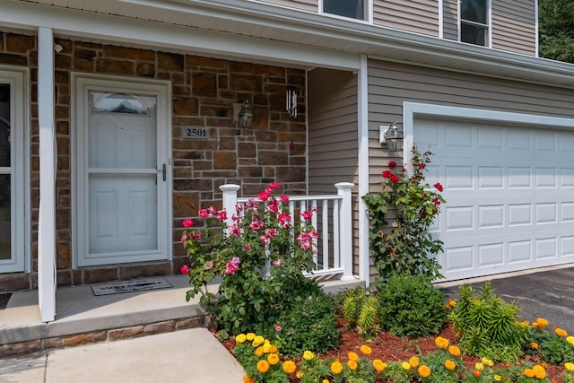 2501 Holiday House Rd, Saint Joseph, MI 49085 - entrance to property featuring a garage, a porch, and stone siding