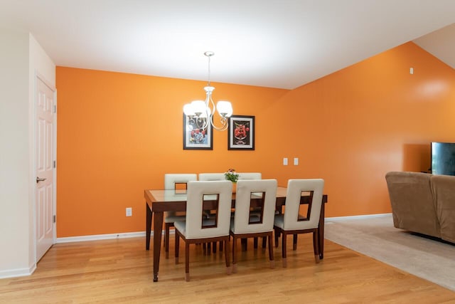 2501 Holiday House Rd, Saint Joseph, MI 49085 - dining space featuring a chandelier, light wood-type flooring, and baseboards