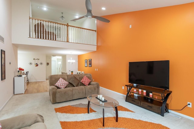 2501 Holiday House Rd, Saint Joseph, MI 49085 - living area with carpet floors, a high ceiling, ceiling fan, baseboards, and a chandelier