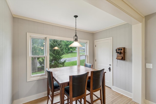 904 Schuring Rd, Portage, MI 49024 - dining area with baseboards, light wood-type flooring, and crown molding