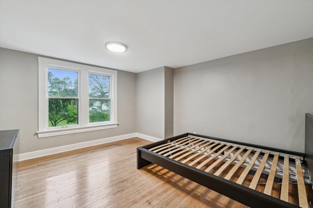 904 Schuring Rd, Portage, MI 49024 - unfurnished bedroom featuring baseboards and light wood-style flooring