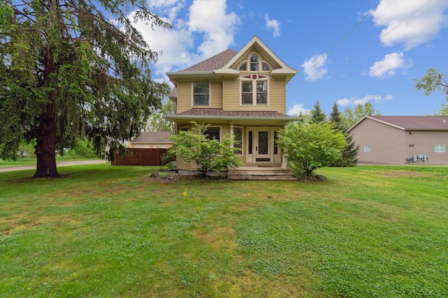904 Schuring Rd, Portage, MI 49024 - victorian home featuring a porch, a front lawn, and a shingled roof