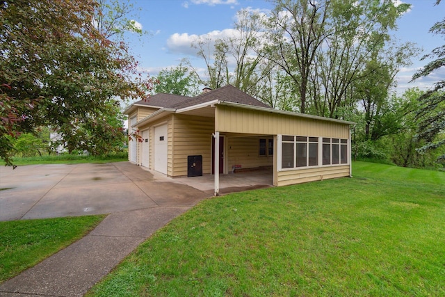 904 Schuring Rd, Portage, MI 49024 - view of side of home with a yard, driveway, a shingled roof, and a sunroom