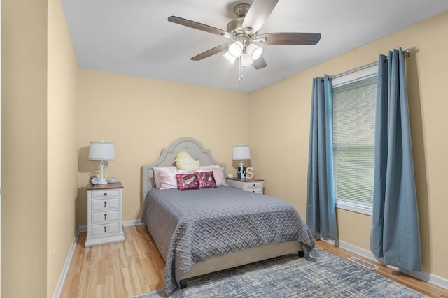 121 W Calgary Dr, Hastings, MI 49058 - bedroom with wood finished floors, baseboards, multiple windows, and a ceiling fan