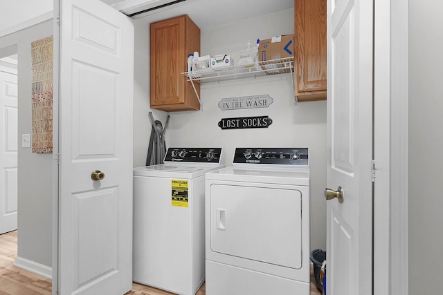 121 W Calgary Dr, Hastings, MI 49058 - laundry room with cabinet space, separate washer and dryer, and light wood-style flooring